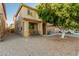 Two-story tan home with a covered front porch and desert landscaping in the front yard at 9350 W Williams St, Tolleson, AZ 85353