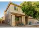Charming two-story tan home featuring a covered front porch and well-maintained landscaping at 9350 W Williams St, Tolleson, AZ 85353
