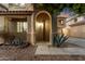 Inviting front entrance with covered porch, arched entryway, and desert landscaping at 9350 W Williams St, Tolleson, AZ 85353