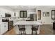 Bright kitchen with white cabinets, quartz countertops, stainless steel appliances, and a stylish island at 9350 W Williams St, Tolleson, AZ 85353