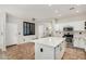 Open-concept kitchen featuring a large island, white cabinets, and stainless steel appliances at 9350 W Williams St, Tolleson, AZ 85353