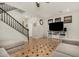 Inviting living area showcasing a large TV, console, and adjacent stairway with decorative elements at 9350 W Williams St, Tolleson, AZ 85353