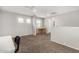 Well-lit loft area featuring carpet floors, bright windows, and neutral paint scheme at 9350 W Williams St, Tolleson, AZ 85353