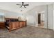Spacious main bedroom with ceiling fan and ensuite bathroom with tile flooring at 9350 W Williams St, Tolleson, AZ 85353