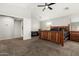 Bright main bedroom featuring a ceiling fan, a wooden bed frame and a walk in closet at 9350 W Williams St, Tolleson, AZ 85353