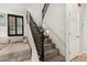 Elegant staircase with carpeted steps, dark wood railings, and natural light streaming through shuttered windows at 9350 W Williams St, Tolleson, AZ 85353