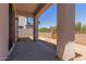 Covered back patio with concrete floor, and privacy wall at 9412 E Sequence Ave, Mesa, AZ 85212