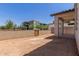 This backyard is enclosed by walls and features a covered patio at 9412 E Sequence Ave, Mesa, AZ 85212