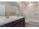 Bathroom featuring double sinks, large mirror and shower/tub combo at 9412 E Sequence Ave, Mesa, AZ 85212