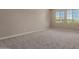 Bright bedroom with neutral carpet, light walls, and view from double windows at 9412 E Sequence Ave, Mesa, AZ 85212