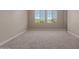 Spacious bedroom with neutral carpet, light walls, and sunny view from double windows at 9412 E Sequence Ave, Mesa, AZ 85212