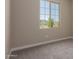 Cozy bedroom with neutral carpet, light walls and view from the window at 9412 E Sequence Ave, Mesa, AZ 85212