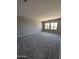 Spacious bedroom with neutral walls, plush carpeting, and large windows at 9412 E Sequence Ave, Mesa, AZ 85212