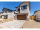 Attractive two-story home with a brown garage door and desert landscaping at 9412 E Sequence Ave, Mesa, AZ 85212