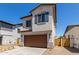 Attractive two-story home with a brown garage door and desert landscaping at 9412 E Sequence Ave, Mesa, AZ 85212
