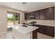 Island kitchen with stainless steel appliances and a view of the backyard at 9412 E Sequence Ave, Mesa, AZ 85212