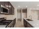 Modern kitchen featuring stainless steel appliances, dark wood cabinets, and white countertops at 9412 E Sequence Ave, Mesa, AZ 85212