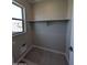 Practical laundry room featuring tile floors, shelving, and a window for natural light at 9412 E Sequence Ave, Mesa, AZ 85212