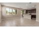 Spacious open-concept kitchen and living room with tile floors and natural light at 9412 E Sequence Ave, Mesa, AZ 85212