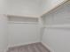Walk-in closet with carpet and wood hanging bar at 9412 E Sequence Ave, Mesa, AZ 85212