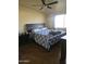 Comfortable bedroom featuring a ceiling fan, a large bed, and good natural lighting at 10307 W Oakmont Dr, Sun City, AZ 85351