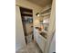Functional laundry area includes a sink, shelving, and cabinets for storage at 10307 W Oakmont Dr, Sun City, AZ 85351