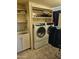 A laundry room is equipped with appliances, a sink and some shelving at 10307 W Oakmont Dr, Sun City, AZ 85351