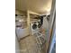 Efficient laundry room with modern appliances, a utility sink, and storage shelves for convenience at 10307 W Oakmont Dr, Sun City, AZ 85351