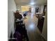 Open-concept living room boasts brick accent wall, dining space, and leads to additional living area at 10307 W Oakmont Dr, Sun City, AZ 85351