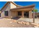 View of the home's backyard featuring a covered patio and low maintenance landscaping at 10956 E Delta Ave, Mesa, AZ 85208