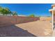 Low maintenance backyard with perimeter block wall and desert landscaping at 10956 E Delta Ave, Mesa, AZ 85208