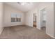 Spacious bedroom with neutral carpeting and ceiling fan at 10956 E Delta Ave, Mesa, AZ 85208