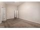 Spacious bedroom with neutral carpeting and multiple entryways at 10956 E Delta Ave, Mesa, AZ 85208