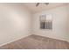 Bedroom with neutral carpet and a window, providing a cozy atmosphere at 10956 E Delta Ave, Mesa, AZ 85208