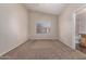 Spacious bedroom with neutral carpeting and a view of the neighborhood at 10956 E Delta Ave, Mesa, AZ 85208