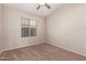 Bright bedroom with a ceiling fan and window offering natural light at 10956 E Delta Ave, Mesa, AZ 85208