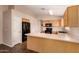 Bright kitchen features wood cabinets, laminate countertops, and stainless steel appliances at 10956 E Delta Ave, Mesa, AZ 85208