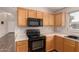 Bright kitchen features wood cabinets, laminate countertops, and stainless steel appliances at 10956 E Delta Ave, Mesa, AZ 85208
