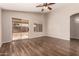 Living room featuring wood-look flooring and sliding glass door for easy outdoor access at 10956 E Delta Ave, Mesa, AZ 85208