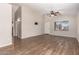 Spacious living room with modern flooring, ceiling fan and neutral color palette at 10956 E Delta Ave, Mesa, AZ 85208