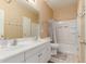 Bright bathroom with double sinks, framed mirror, tub, and shower at 11836 W Planada Ct, Sun City, AZ 85373