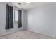 Bedroom with neutral carpet, window with blinds, and grey curtains at 11836 W Planada Ct, Sun City, AZ 85373