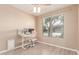 Bedroom with hardwood floors, pink desk chair, and blinds at 11836 W Planada Ct, Sun City, AZ 85373