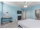 Bright primary bedroom featuring a desk, TV, and ensuite bath access at 11836 W Planada Ct, Sun City, AZ 85373