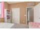 Cozy bedroom with carpet, white sliding-door closet, and shelving unit at 11836 W Planada Ct, Sun City, AZ 85373