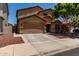 Charming two-story home featuring a well-manicured front yard and a two-car garage at 11836 W Planada Ct, Sun City, AZ 85373