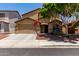 Charming two-story home featuring a well-manicured front yard and a two-car garage at 11836 W Planada Ct, Sun City, AZ 85373