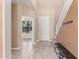 Inviting home foyer featuring hard surface floors, a staircase, and a bench at 11836 W Planada Ct, Sun City, AZ 85373