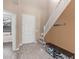 Inviting home foyer featuring hard surface floors, a staircase, and a bench at 11836 W Planada Ct, Sun City, AZ 85373