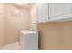 Bright laundry room with white cabinets and washer and dryer at 11836 W Planada Ct, Sun City, AZ 85373